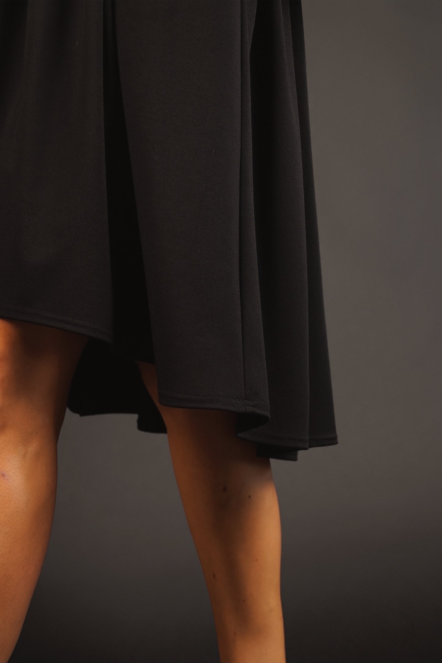 Kleita ar slīpu volānu un paplatinātām piedurknēm