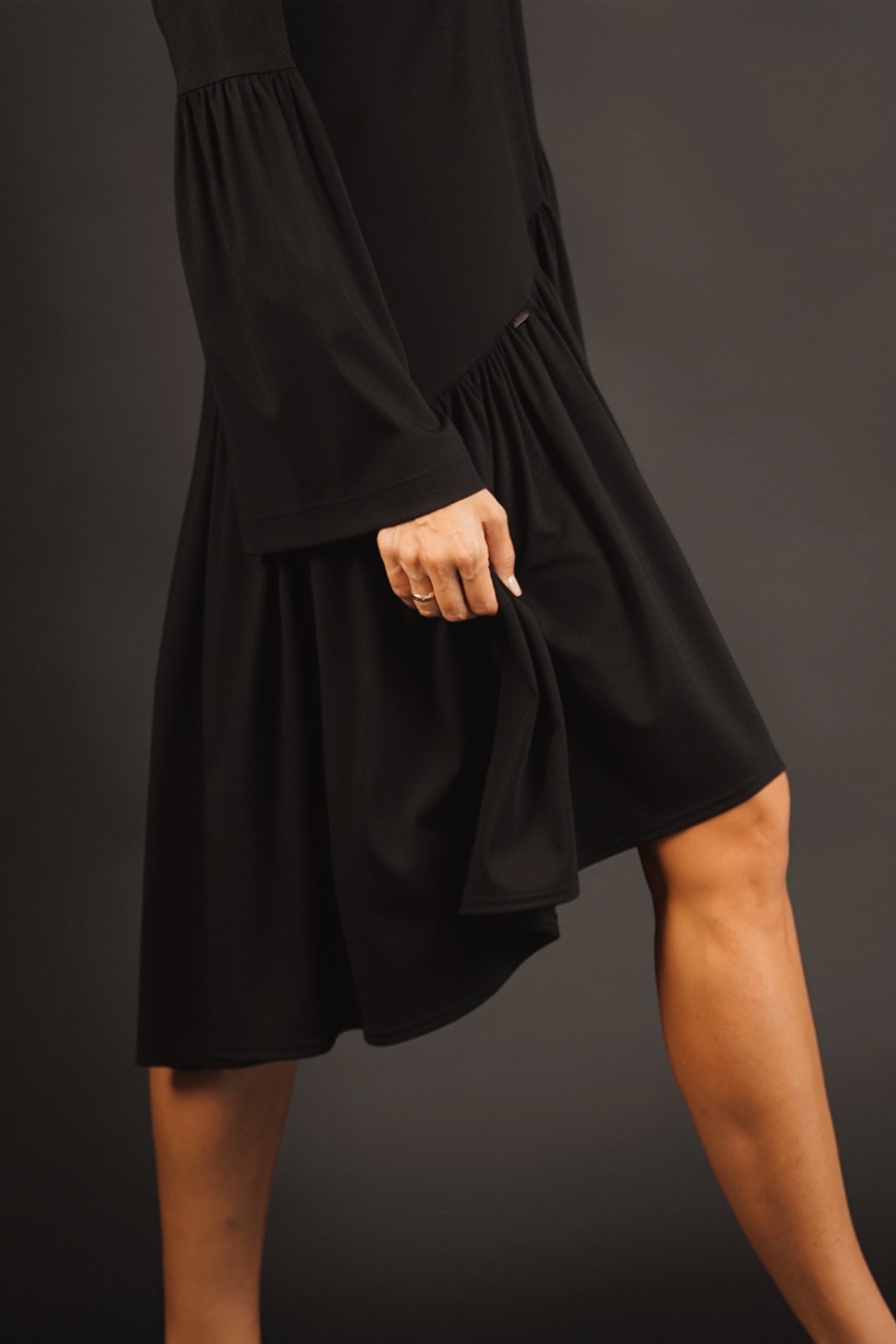 Kleita ar slīpu volānu un paplatinātām piedurknēm